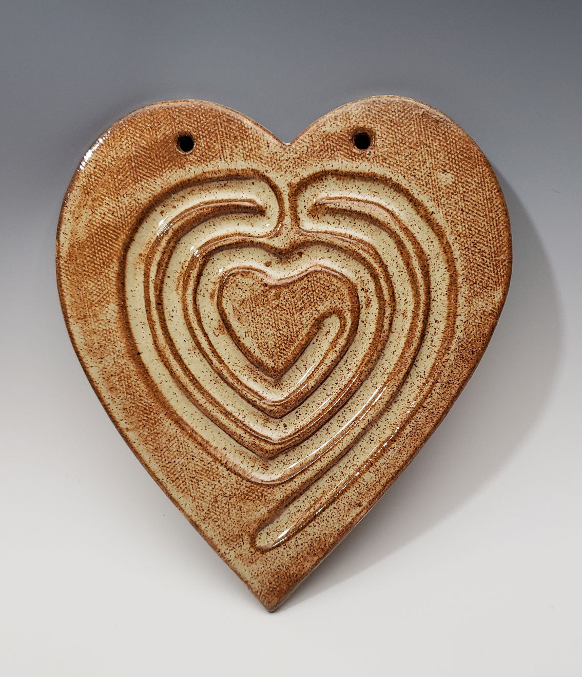Ceramic heart-shaped labyrinth on a gray background