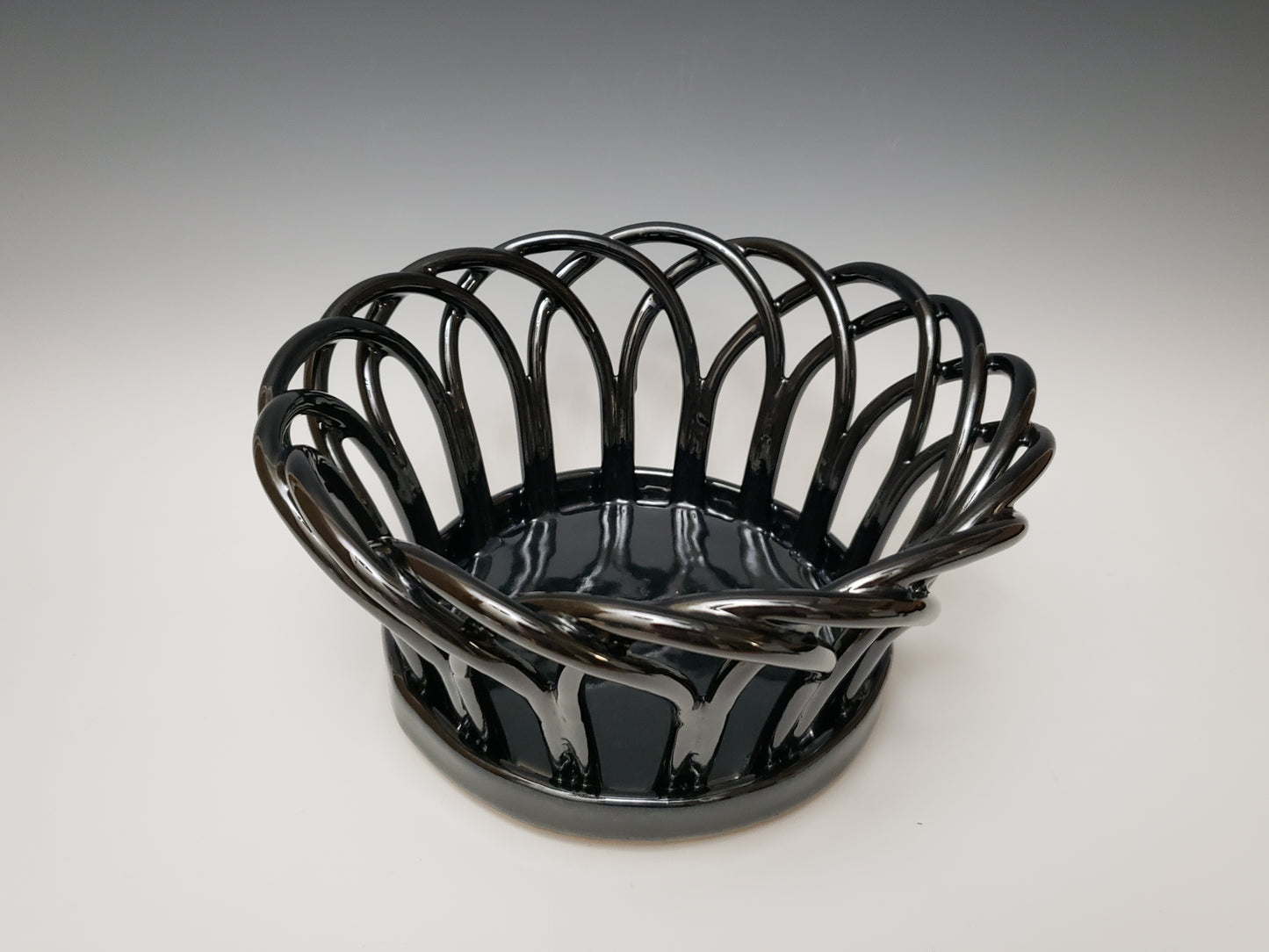 Black stoneware basket on a white background