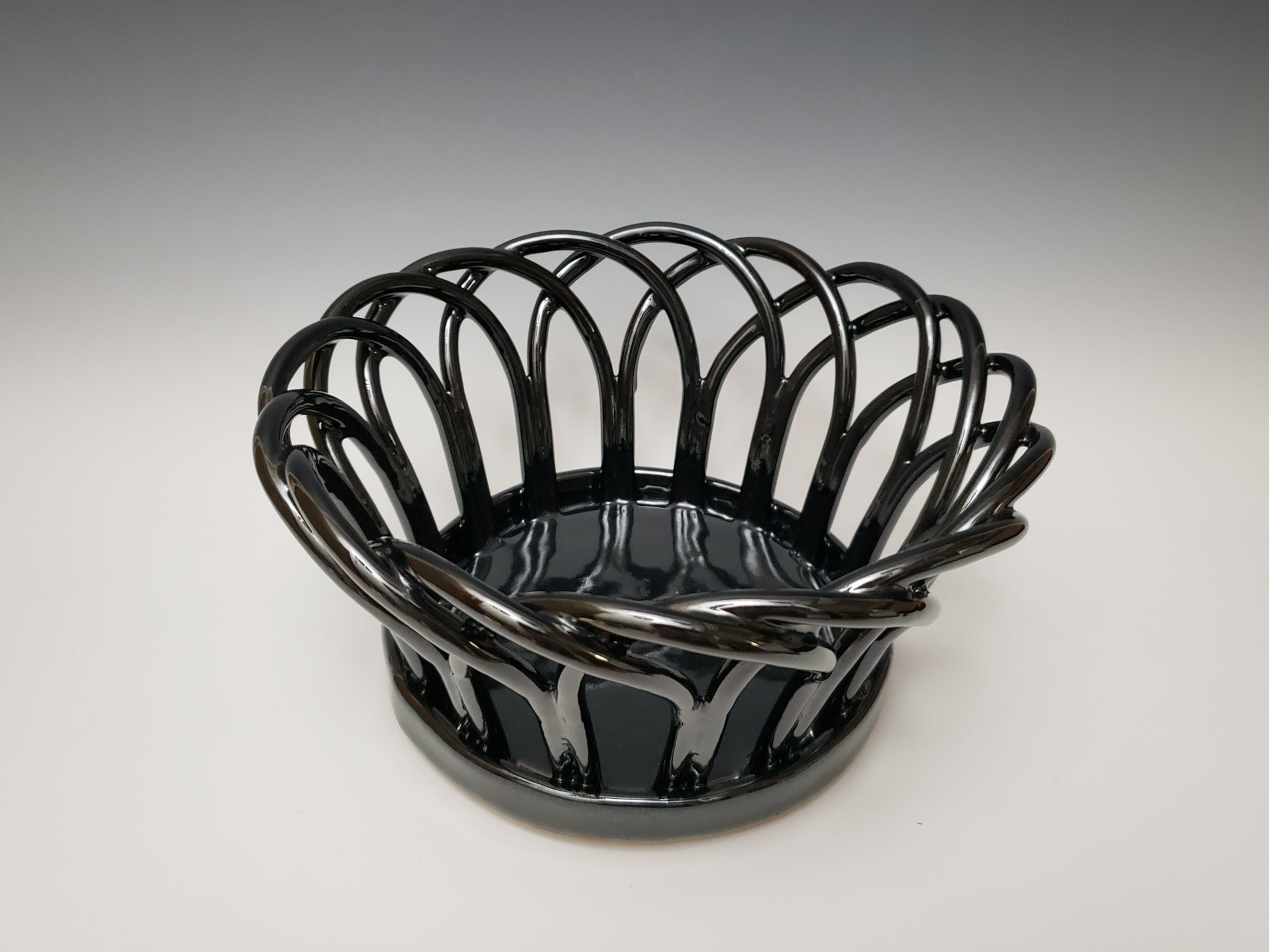 Black stoneware basket on a white background
