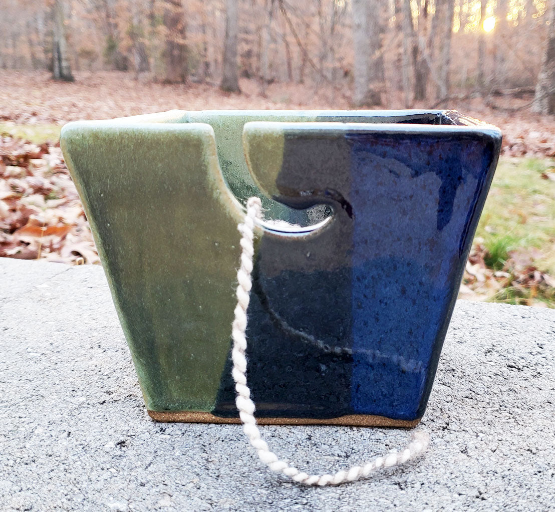 Dark blue & green stoneware yarn bowl on a white background