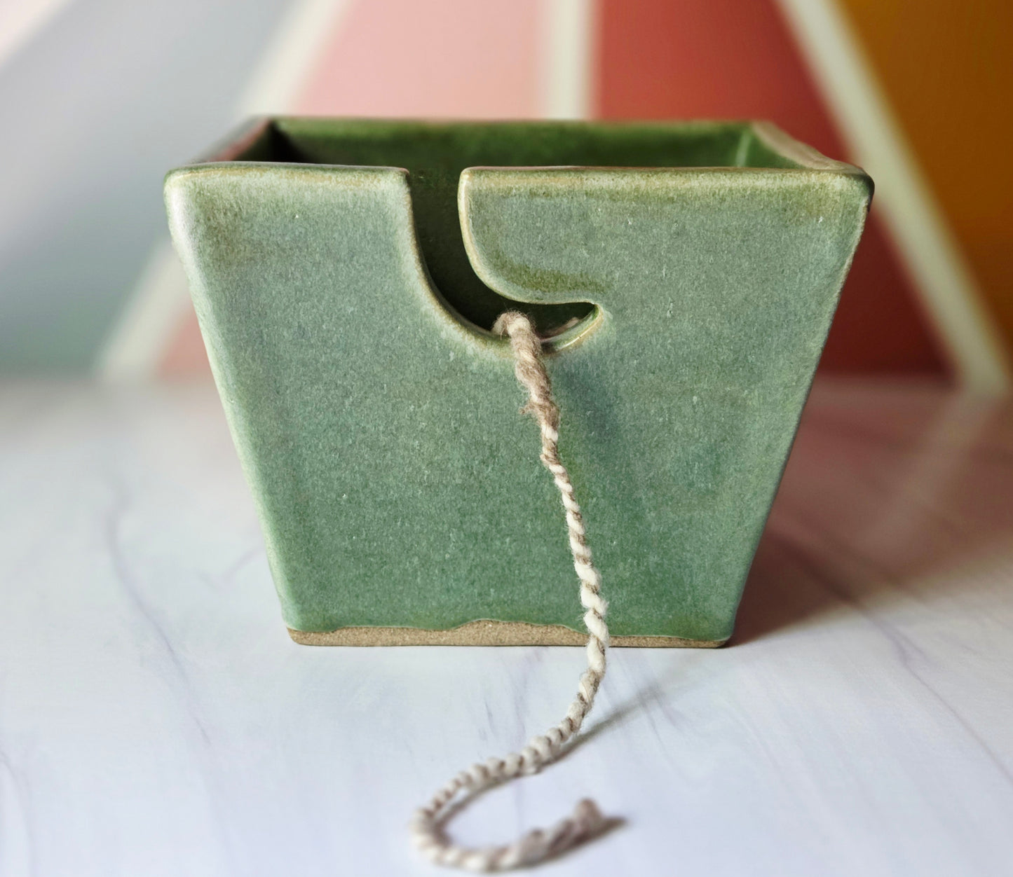 Moss stoneware yarn bowl on a multi-color background