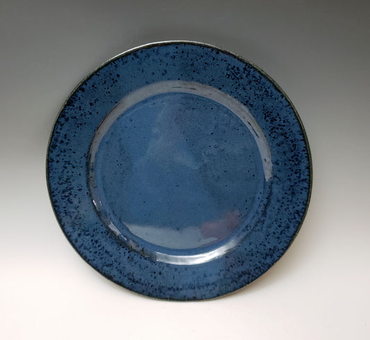 Blue ceramic plate on a gray background